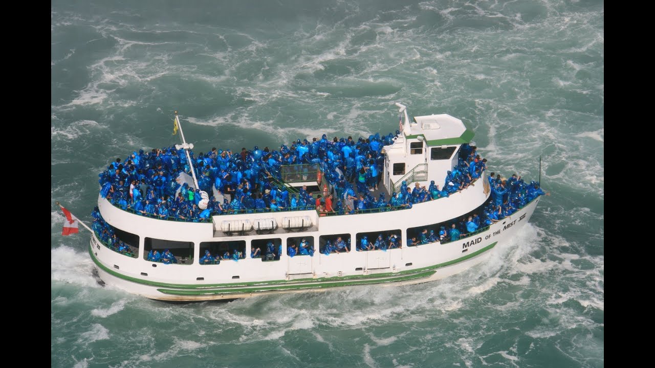 Maid of the Mist boat approaching the Horseshoe Falls with mist in the air in Niagara Falls, Ontario.