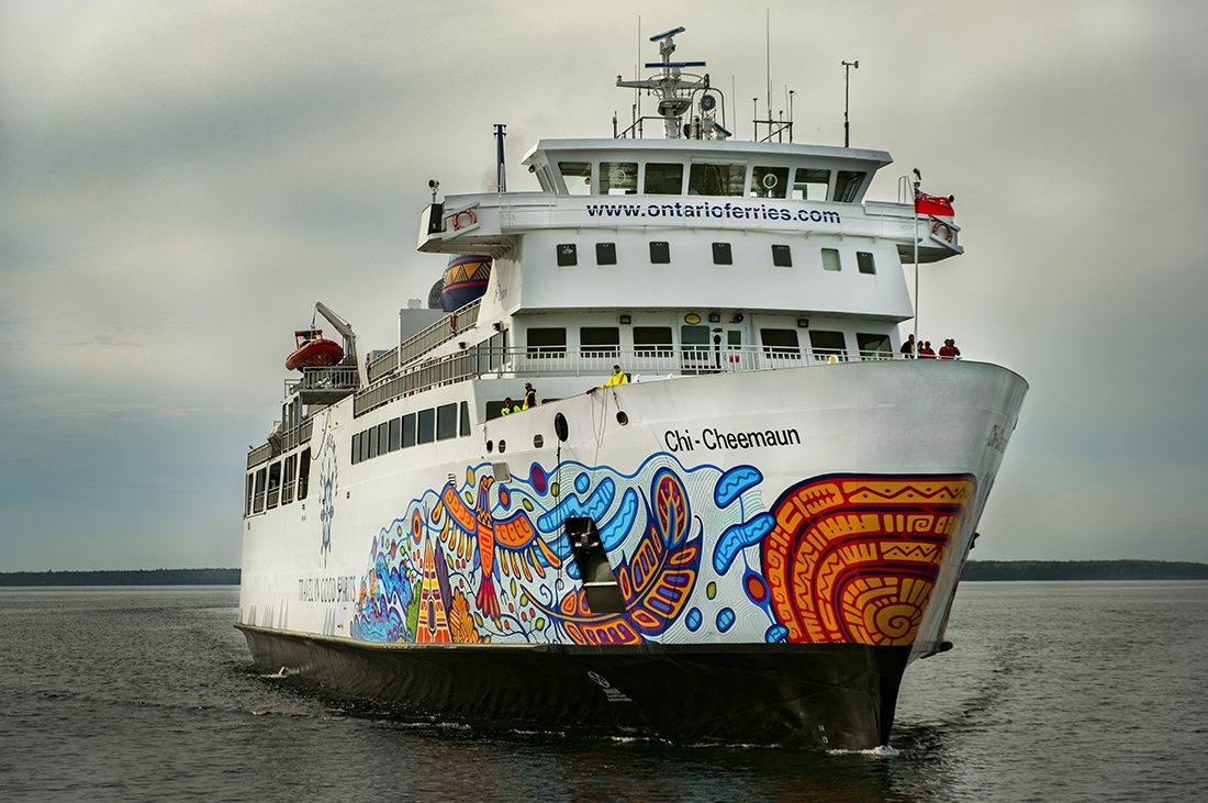 MS Chi-Cheemaun ferry on the water, approaching or departing a dock in Northern Ontario.